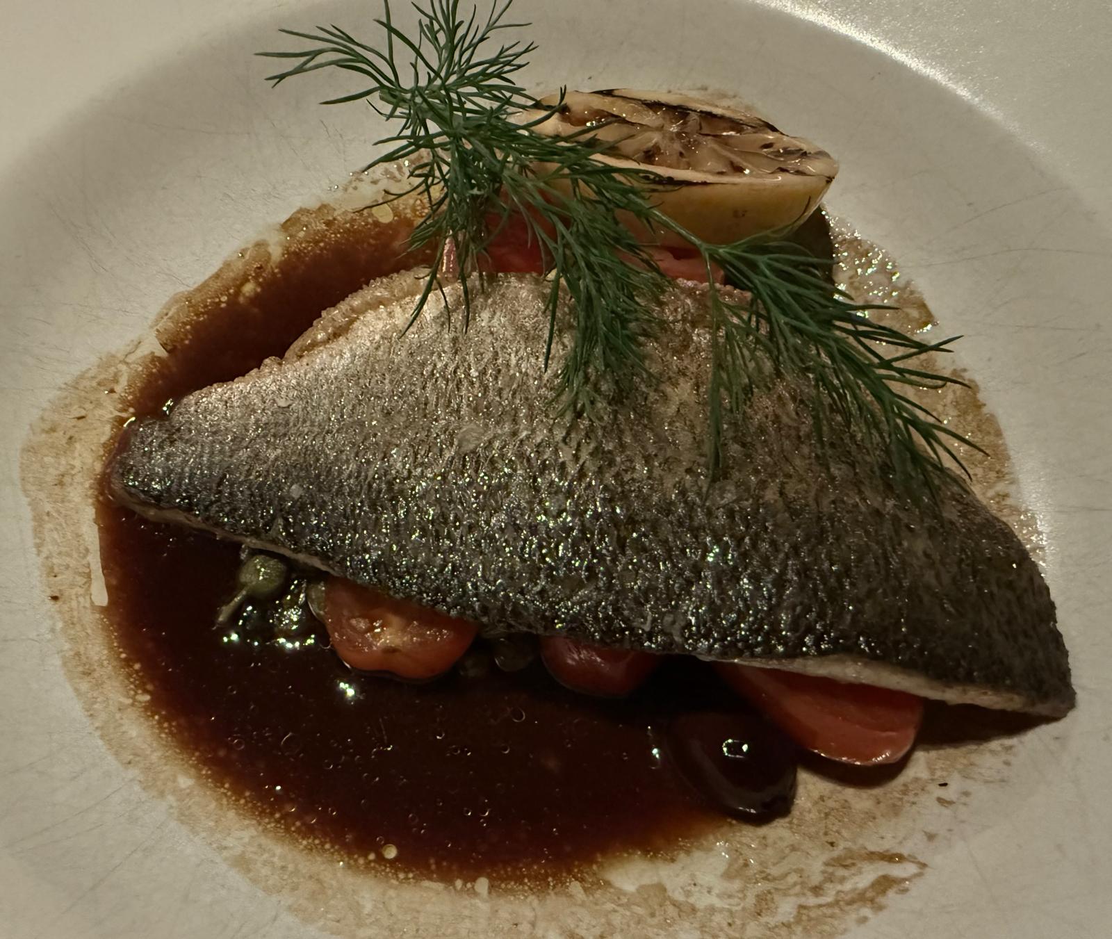 Pan fried sea bass with tomatoes and capers